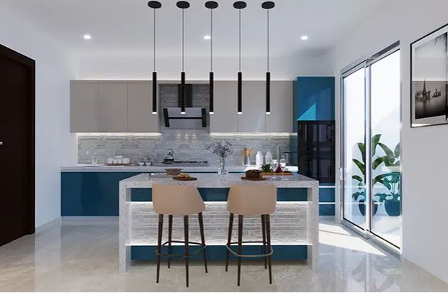 Modern modular kitchen design featuring a stylish island with bar stools, pendant lighting, sleek blue and grey cabinetry, and a bright layout with natural light from sliding glass doors.